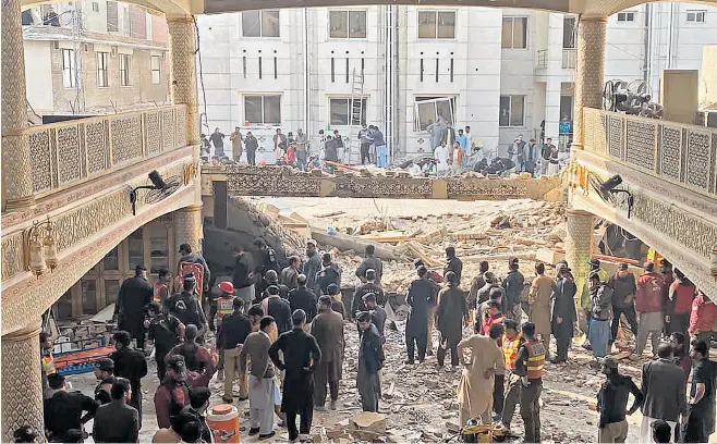  ?? ?? ‘I saw black smoke rising. I ran out to save my life. Screams of people for help are still echoing in my mind’
Security officials inspect the damage at the mosque in Peshawar