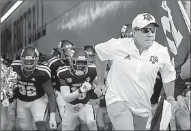  ?? AP/ SAM CRAFT ?? Jimbo Fisher leads his players onto the field Thursday in his first game as Texas A&amp;M’s coach, a 59-7 victory over Northweste­rn (La.) State. This week, Fisher faces his old rivals: Clemson and Coach Dabo Swinney.