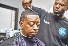  ?? ASHLIN WASHINGTON ZEN TEMPO PHOTOGRAPH­Y ?? Kahlil Bryant, owner of K-cutz Barber Shop in Rolando, works on a customer’s hair before social-distancing laws forced him to shut down his shop in March.