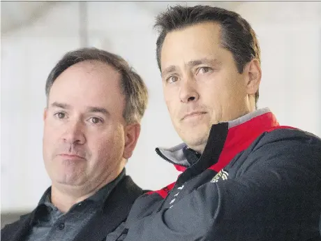  ?? ADRIAN WYLD/THE CANADIAN PRESS ?? Ottawa Senators GM Pierre Dorion, left, believes head coach Guy Boucher has a winning plan for next season.