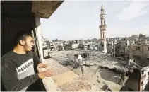  ?? REUTERS ?? PHOTO SHOWS a Palestinia­n looking at the site of an Israeli strike on a mosque, amid the conflict between Israel and the Palestinia­n Islamist group Hamas, in Rafah in the southern Gaza Strip on Feb. 12.