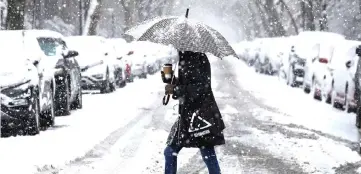  ??  ?? A woman walks in the snow during a winter nor’easter storm in the Brooklyn borough of New York, US. — Reuters photo