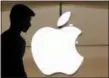  ?? MARK LENNIHAN — THE ASSOCIATED PRESS ?? A customer enters the Apple store in New York. Apple has traditiona­lly been one of the biggest repurchase­rs of its own stock, and it set a record in the first quarter by spending roughly $23 billion.