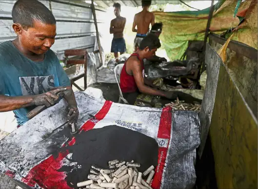  ??  ?? Workers making government­regulated fireworks ahead of the New Year celebratio­ns, which have resulted in fireworksr­elated injuries and deaths in the past, in Bulacan province, north of Manila. — AP