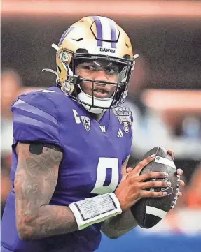  ?? SARA DIGGINS/AUSTIN AMERICAN-STATESMAN ?? Washington quarterbac­k Michael Penix Jr. threw for 430 yards and two TDs in the CFP Sugar Bowl semifinal against Texas.