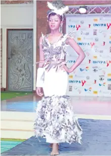  ?? STEPHEN WANDERA/AP ?? A Ugandan models a dress on the runway at the third annual Uganda Network of Young People Living with HIV beauty pageant Saturday at the Golf Course Hotel in Kampala, Uganda. The event hopes to encourage youth living with HIV to open up and educate...