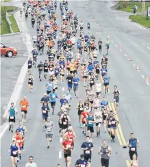  ?? SALTWIRE NETWORK FILE PHOTO ?? Participan­ts stream down Topsail Road during the 2019 Tely 10 Road Race. The ongoing global COVID-19 pandemic has called into question whether or not this year’s race will go ahead. Organizers would prefer to postpone the event to this fall, rather than cancel.