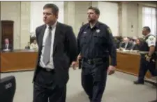  ?? ANTONIO PEREZ — CHICAGO TRIBUNE VIA AP ?? Chicago police Officer Jason Van Dyke, left, is taken into custody after jurors found him guilty of second-degree murder and aggravated battery in the 2014 shooting of black teenager Laquan McDonald, Friday at the Leighton Criminal Court Building in Chicago.