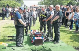  ??  ?? LAID TO REST: Mr Cooney’s coffin is lowered into the ground at Pudsey Cemetery, Leeds.