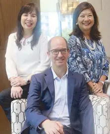  ??  ?? Shang Properties director of property management Miguel Feuermann is flanked by marketing director Milen G. Treichler (right) and sales director Susan Lee Yu in the lobby of Shang Salcedo Place, which carries the signature scent of Shang hotels.
Photo...