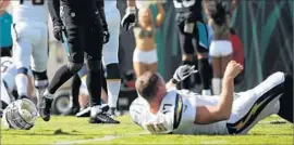  ?? Logan Bowles Getty I mages ?? PHILIP RIVERS of the Chargers took several hard hits against the Jaguars and went into concussion protocol. He was throwing passes Wednesday.