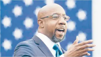  ?? DREW ANGERER/GETTY ?? The Rev. Raphael Warnock campaigns Dec. 15 in Atlanta. Warnock will try to unseat Georgia Republican Sen. Kelly Loeffler on Jan. 5, one of two runoff races that will decide control of the Senate.