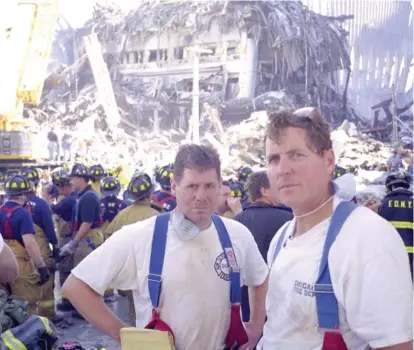  ?? PROVIDED PHOTO ?? Pat Maloney (left) and a fellow Chicago firefighte­r stand near the site of the 9/11 attacks in New York City.