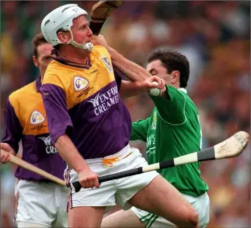  ??  ?? Tom Dempsey beats Limerick defender Declan Nash to the ball in the All-Ireland Senior final of 1996.