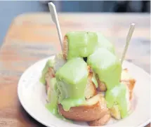  ??  ?? Sangkaya, or Thai pandan custard over bread.