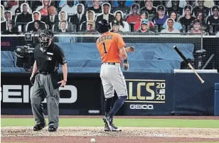  ?? JAE C. HONG THE ASSOCIATED PRESS ?? Houston’s Carlos Correa tosses his bat and has words with home plate umpire Lance Barksdale after striking out during Game 7 of the American League Championsh­ip Series on Saturday.