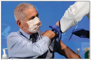  ?? (AP/Patrick Semansky) ?? Dr. Anthony Fauci, the nation’s top infectious disease expert, gets his first dose of the Moderna vaccine Tuesday at the National Institutes of Health in Bethesda, Md. Fauci said he expects most Americans to have access to the injections by midsummer.