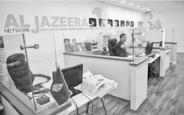  ??  ?? An employee of Al-Jazeera at the channel’s Jerusalem office. — AFP photo