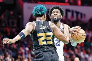  ?? (AP Photo/Nell Redmond) ?? Philadelph­ia 76ers center Joel Embiid (21) is fouled by Charlotte Hornets forward Kai Jones (23) during the second half of an NBA basketball game Friday in Charlotte, N.C.
