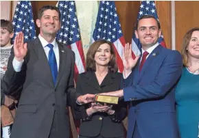  ?? ASSOCIATED PRESS ?? House Speaker Paul Ryan (left) of Wisconsin administer­s the House oath of office to Rep. Mike Gallagher (R-Wis.) during a swearing in ceremony Jan. 3 on Capitol Hill in Washington.