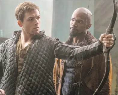  ?? LIONSGATE FILMS ?? Taron Egerton, left, and Jamie Foxx share a moment of clarity in the latest adaptation of the Robin Hood legend.