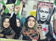  ?? AP PHOTO ?? Turkish protesters shout anti-Russia slogans as they hold a poster of Russian President Vladimir Putin that reads in Turkish and Russian “Assassin Putin! “during a protest in Istanbul, Turkey, Friday.