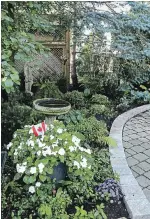  ??  ?? The Halls’ garden design was shaped by trips to Italy. Their own take includes more plants to soften the hard surfaces. Statuary, much of it purchased at Kastrau Landscapin­g and Nurseries in Hamilton, has been added over the years.