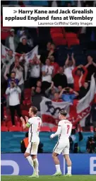  ?? Laurence Griffiths/ Getty Images ?? > Harry Kane and Jack Grealish applaud England fans at Wembley