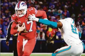  ?? Timothy T Ludwig / TNS ?? The Miami Dolphins will have to limit Buffalo Bills quarterbac­k Josh Allen from running all over their defense, as he did in their last meeting at Highmark Stadium on Dec. 17 in Orchard Park, N.Y.