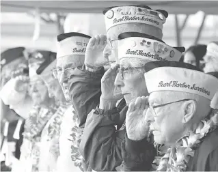  ??  ?? Pearl Harbor survivors salute during the National Anthem at a ceremony in Pearl Harbor, Hawaii on Friday (Saturday in Manila) marking the 77th anniversar­y of the Japanese attack. The Navy and National Park Service jointly hosted the remembranc­e ceremony at a grassy site overlookin­g the water and the Memorial. USSArizona
