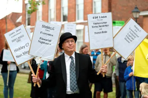  ??  ?? POWER TO THE PEOPLE: Protesters march at Bridgwater, Somerset, over plans to invest £18 billion in the nuclear power station at Hinkley Point. Photo: Andrew Matthews/PA Wire