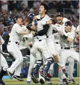  ?? WILFREDO LEE — THE ASSOCIATED PRESS ?? Shohei Ohtani, middle, celebrates with teammates after Japan beat the U.S. for the WBC title Tuesday.