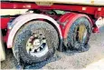  ??  ?? A lorry’s tyres are covered in sticky black bitumen after driving on a melting road