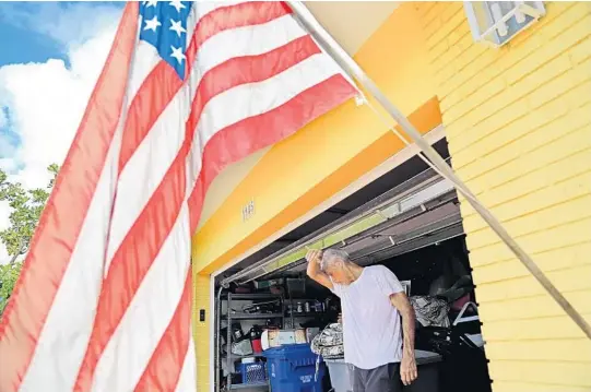  ?? AMY BETH BENNETT/STAFF PHOTOGRAPH­ER ?? Bill Schumacher wipes the sweat from his eyes while securing his Lauderdale-by-the-Sea home in preparatio­n for Hurricane Irma on Friday.