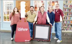  ?? ?? Stevan Black (middle holding frame) met at Starkville Public Library to pick up his one-ofa-kind plate that he won in an auction. (From left to right: Jessica Lindsey, Phillip Carter, Stevan Black, Mark Wood, and Ronald Oswalt) (Photo by Cal Brown, SDN)