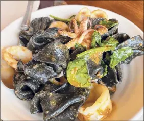  ?? Susie Davidson Powell / For the Times Union ?? Soprese pasta, which looks like tortellini without the filling, is colored by squid ink at feast & Floret in Hudson..