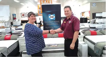  ??  ?? Maz Byrne being presented with her Sealy bedding package by Furniture Plus store manager Mark Garvey.