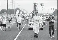  ?? AP/ERIC GAY ?? Altar server Anthoney Saenz (second from right) waves incense Saturday as he helps lead a procession toward the Rio Grande to oppose the wall the U.S. wants to build at the Mexican border.