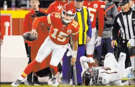  ?? Charlie Riedel The Associated Press ?? Chiefs quarterbac­k Patrick Mahomes runs past Broncos linebacker Bradley Chubb on Sunday in Kansas City, Mo. Mahomes had 184 yards passing with a touchdown run in the win.