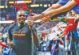  ?? THE ASSOCIATED PRESS ?? Atlanta Hawks forward Paul Millsap acknowledg­es fans as he runs to the locker room before a home game against the Cleveland Cavaliers on March 3. He will be a free agent this summer but might stay in Atlanta.