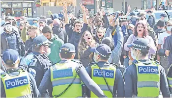  ?? — AFP photo ?? Anti-lockdown protesters chant slogans at Melbourne’s Queen Victoria Market during a rally, amid the ongoing Covid-19 coronaviru­s pandemic.