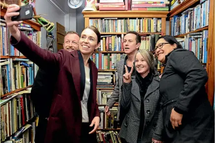  ?? LOREN DOUGAN/STUFF ?? Labour leader Jacinda Ardern takes a selfie in Masterton; below, Ardern meets a small fan as the rain comes down in Wairarapa yesterday.