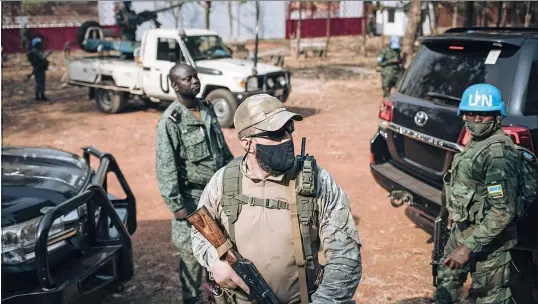  ?? ?? Above: A Russian private security agent and a member of the Central African Republic presidenti­al guard on a joint mission in Bangui.
Opposite: Russian President Vladimir Putin attending the plenary session of the second Russia-Africa summit in Saint Petersburg.