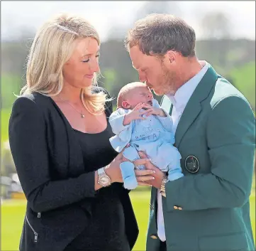  ??  ?? BRINGING HOME THE BOOTY: Danny Willett shows off his green jacket to newborn son Zacariah and wife Nicole