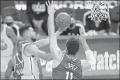  ?? JEFF CHIU — THE ASSOCIATED PRESS ?? Warriors guard Stephen Curry, left, shoots against Bucks center Brook Lopez during the first half Tuesday.