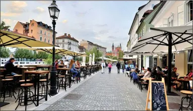  ?? (Rick Steves) ?? Ljubljana’s riverfront promenade is lined with quaint boutiques, great restaurant­s, and cafés ripe for people-watching.