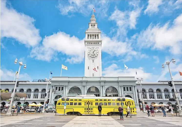  ?? PHOTOS: JUSTIN FRANZ/THE WASHINGTON POST ?? San Francisco’s historic Ferry Building, known for its clock tower, is among the stops on a vintage trolley tour through the city.