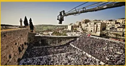  ?? PHOTO: NICHOLAS RUEL ?? A camera shoots an aerial view of the plaza at the Western Wall during Passover. The scene appears in Jerusalem, the first Imax film made in the city. Its producers were given unpreceden­ted access to holy sites to capture Jews, Muslims and Christians...