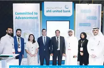  ??  ?? KUWAIT: Tareq Muhmood with AUB representa­tives receive visitors at the bank’s booth during the conference.