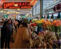  ?? PIKE PLACE MARKET PDA ?? Flower stalls, produce stands and fish markets fill Seattle's iconic Pike Place Market.